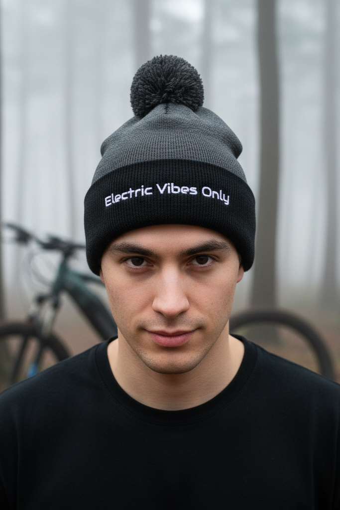 dark heather grey/ black pom pom beanie - man with e-bike in foggy forest. background